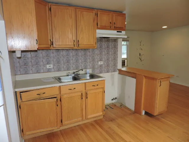 a kitchen with granite countertop a sink and a stove top oven