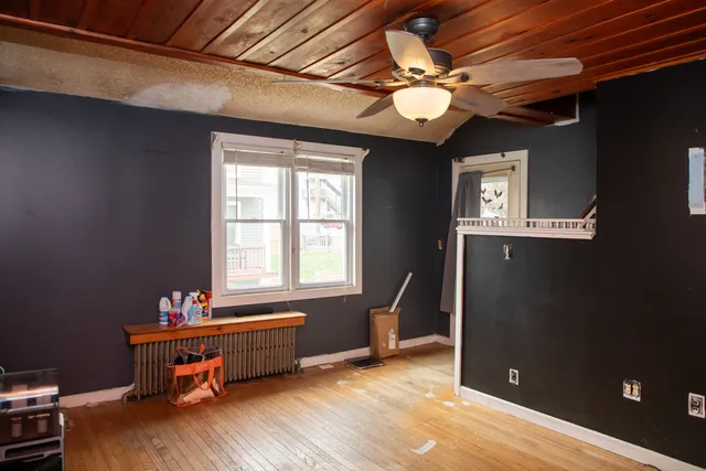 a kitchen with stainless steel appliances a stove a sink a dining table and chairs