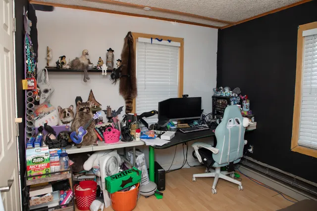 a reading room with wooden floor and a window
