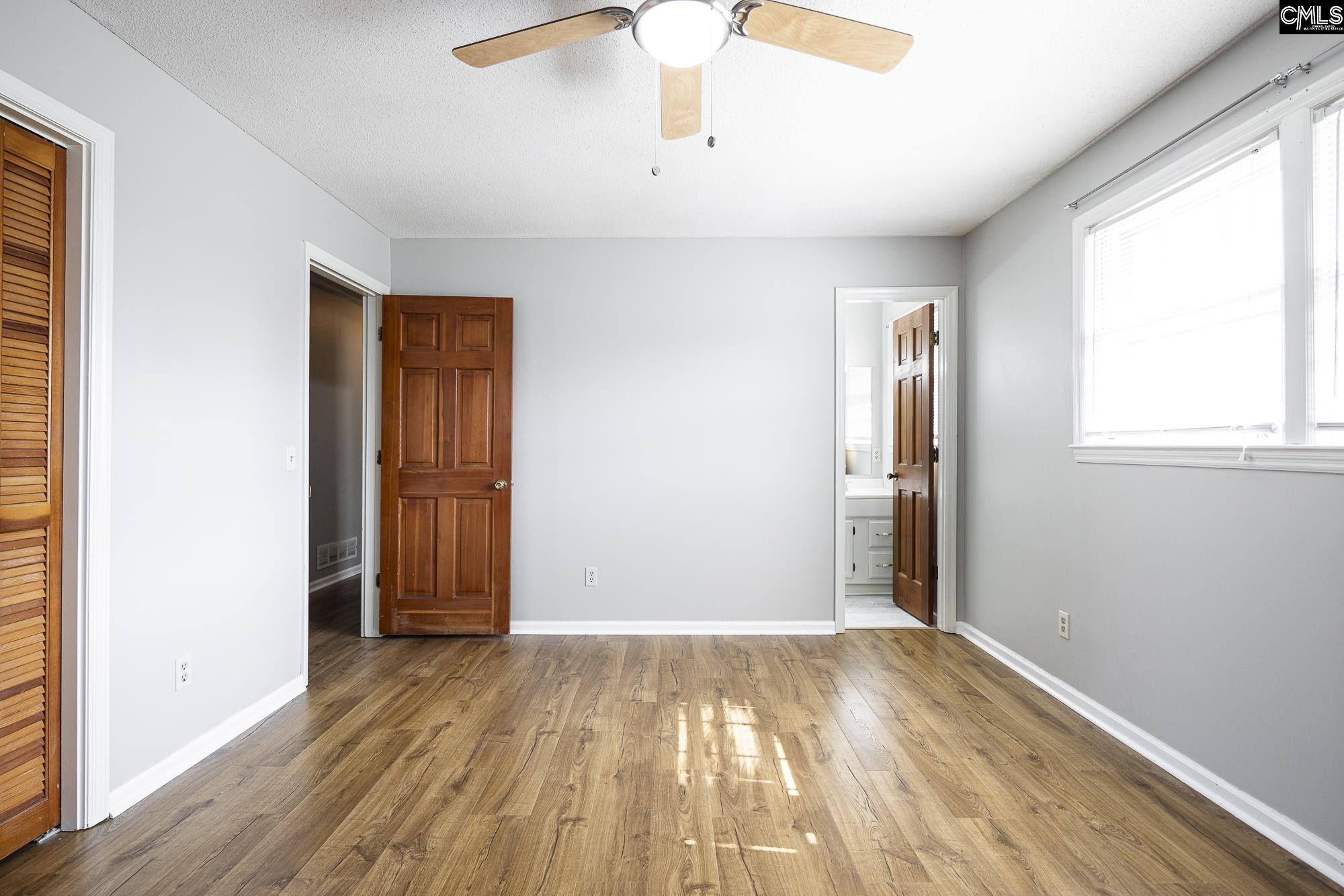 4083 Platt Springs Road West Columbia, SC 29170 - Photo 22 of 35 wooden floor in an empty room with a window
