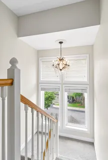 a bedroom with a bed and a flat tv screen on dresser