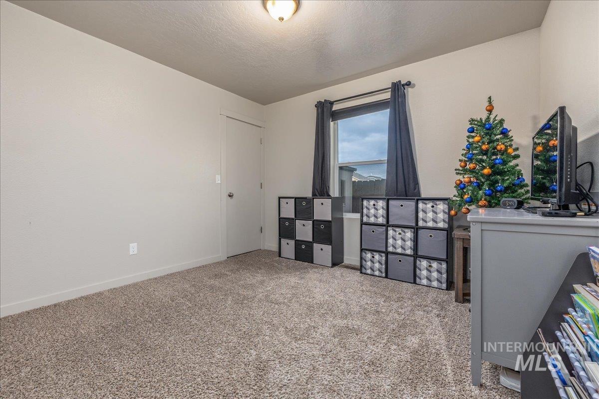 661 North Scotney Avenue Meridian, ID 83642 - Photo 15 of 22 Bedroom with light carpet and a textured ceiling