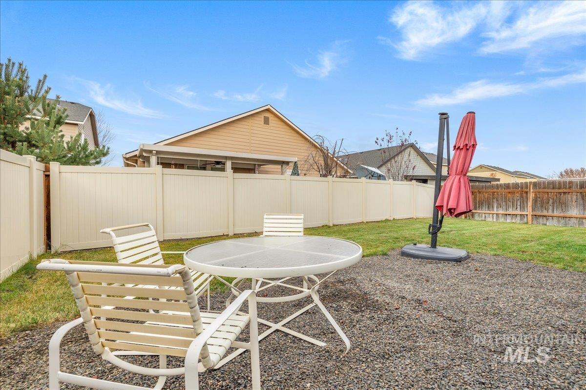 661 North Scotney Avenue Meridian, ID 83642 - Photo 18 of 22 Fenced backyard featuring a patio and outdoor dining space