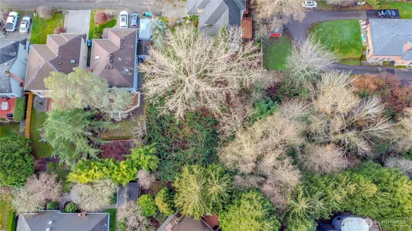 an aerial view of a house with a yard and garden