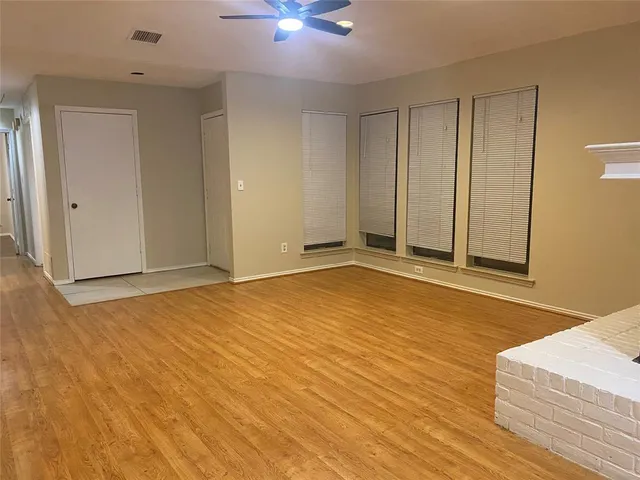 a view of an empty room with a ceiling fan