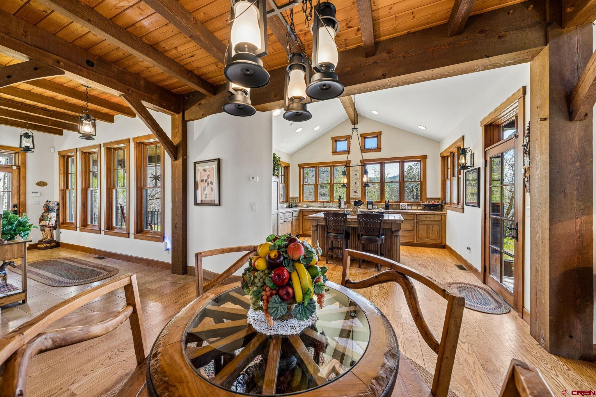 3623 Elkhorn Mountain Road Durango, CO 81301 - Photo 12 of 44 a view of a dining room with furniture a chandelier and wooden floor