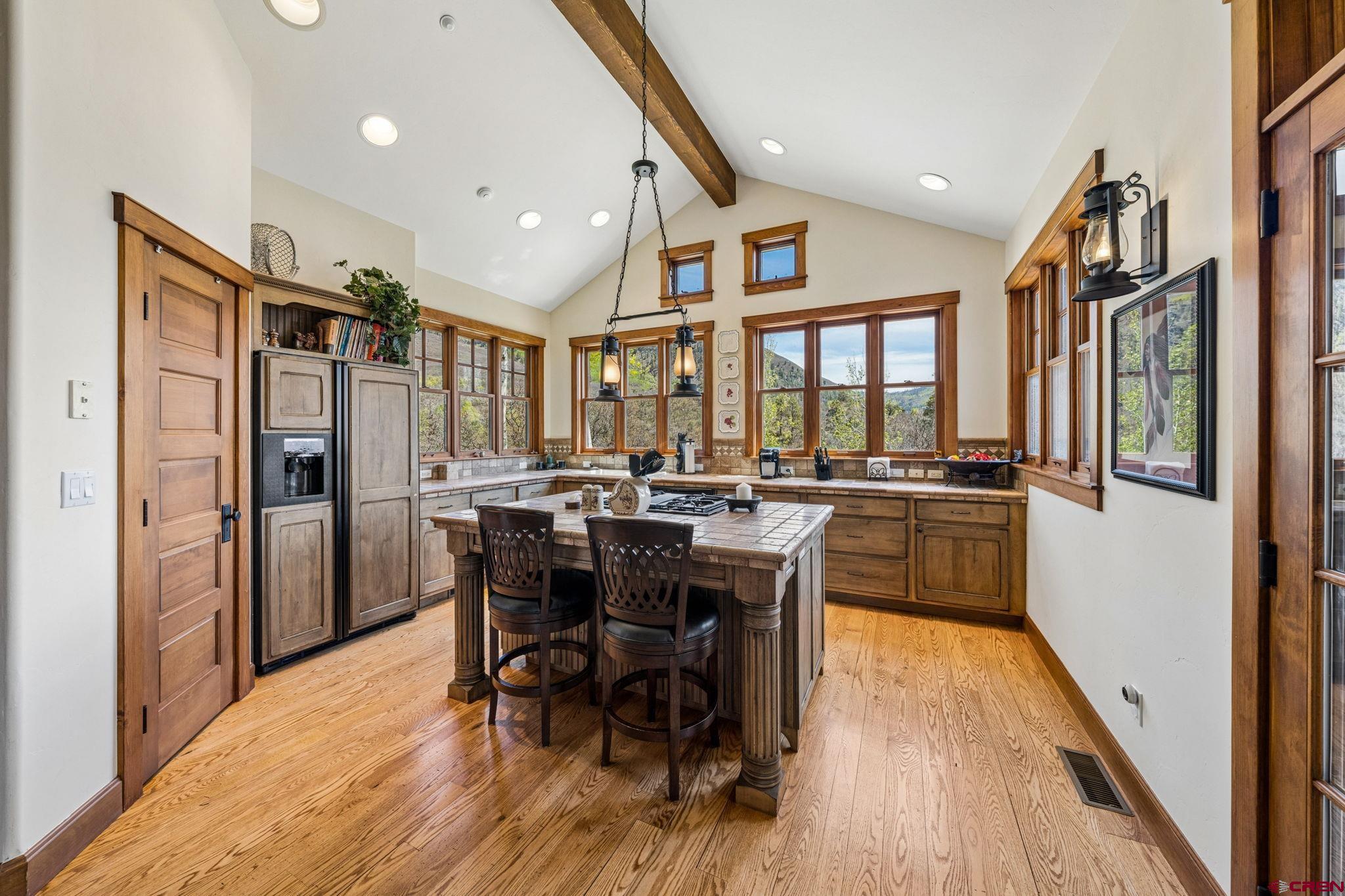 3623 Elkhorn Mountain Road Durango, CO 81301 - Photo 13 of 44 a kitchen with stainless steel appliances granite countertop a refrigerator a sink a stove and a dining table with wooden floor