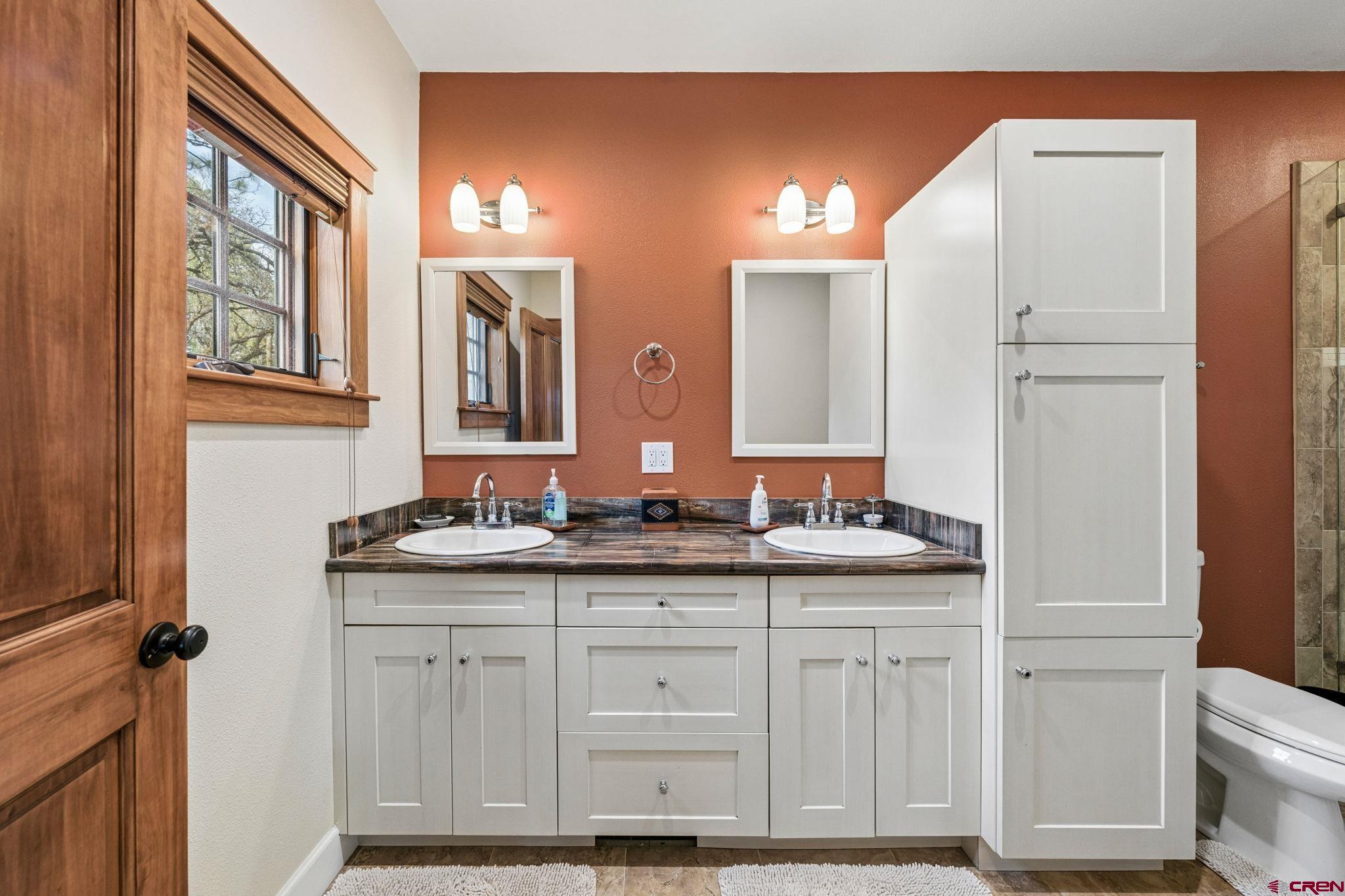 3623 Elkhorn Mountain Road Durango, CO 81301 - Photo 34 of 44 a bathroom with a granite countertop double vanity sink a mirror and a vanity