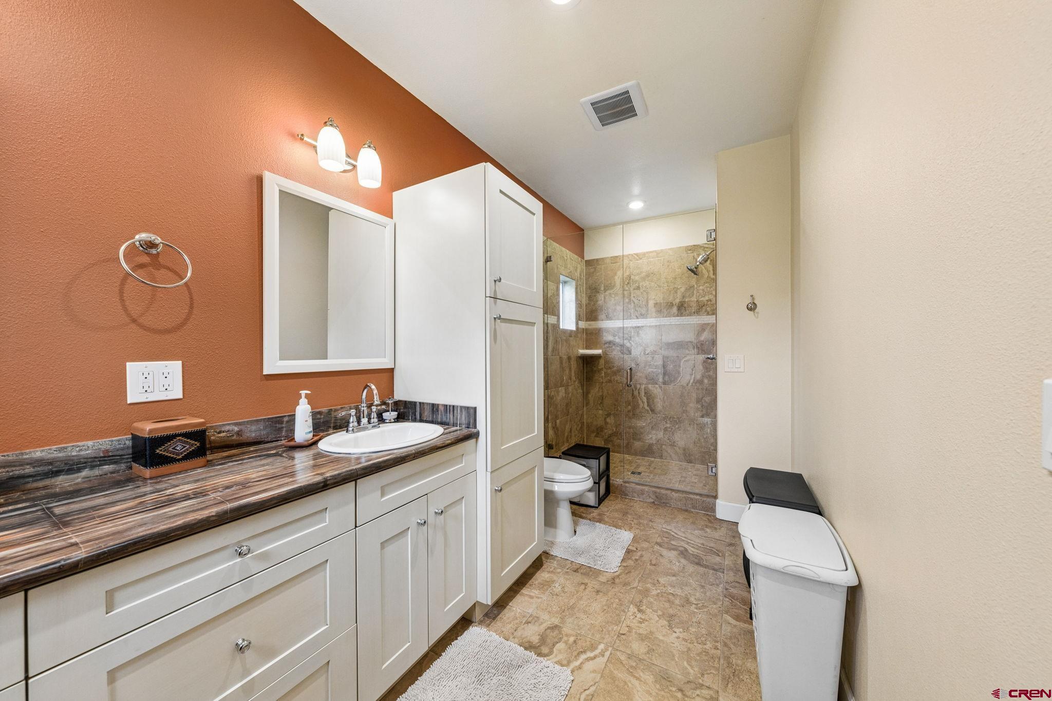 3623 Elkhorn Mountain Road Durango, CO 81301 - Photo 35 of 44 a spacious bathroom with a granite countertop sink a toilet a mirror and shower