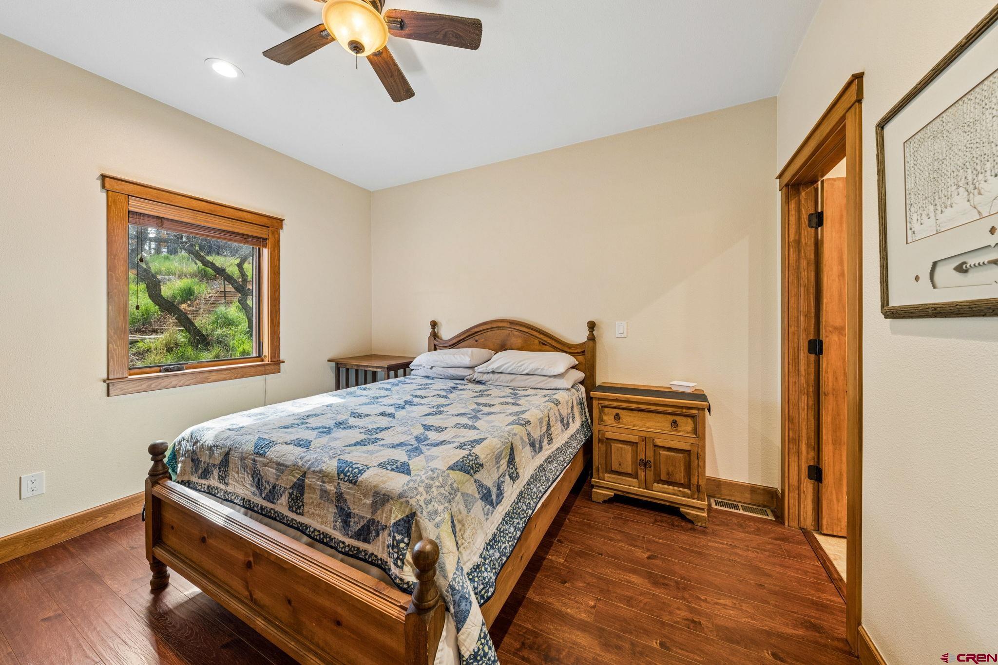 3623 Elkhorn Mountain Road Durango, CO 81301 - Photo 36 of 44 a bedroom with a bed and a chandelier