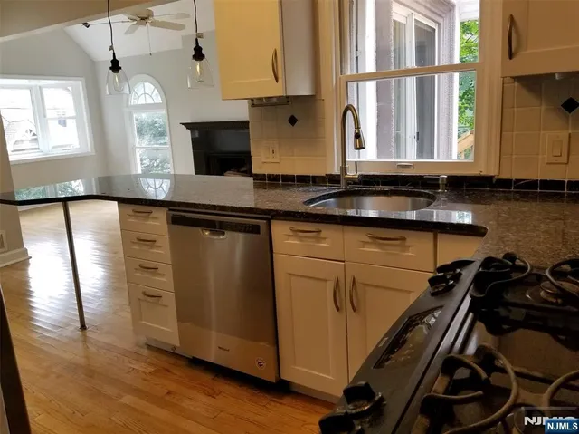 a kitchen with a sink window and cabinets