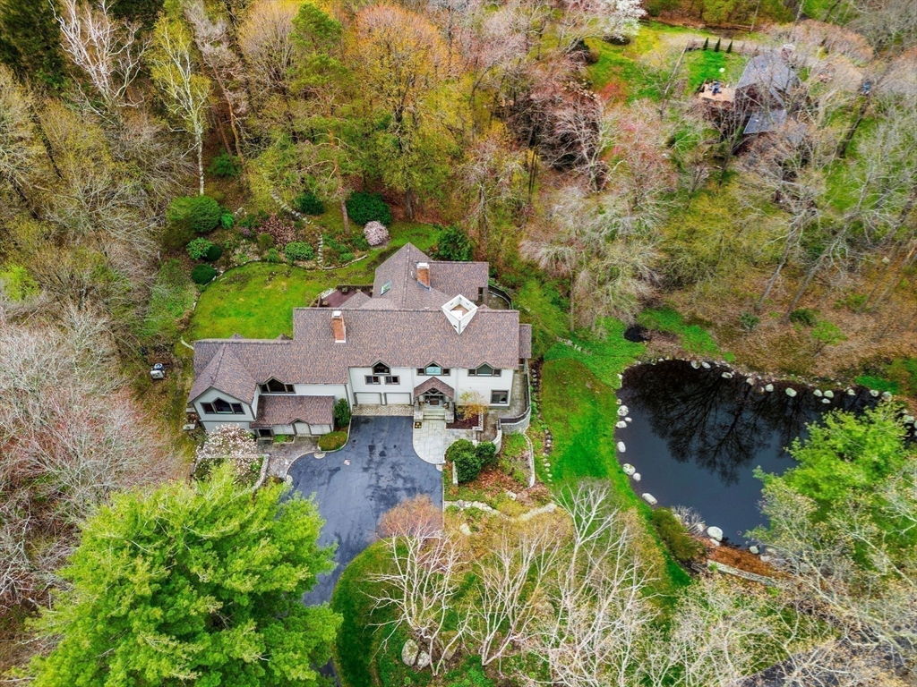 an aerial view of a house with a yard