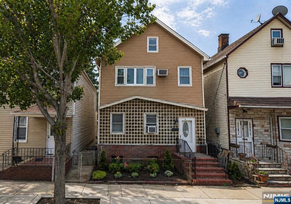 40 Searing Avenue, Unit 2 Harrison, NJ 07029 - Photo 1 of 11 a front view of a house with plants