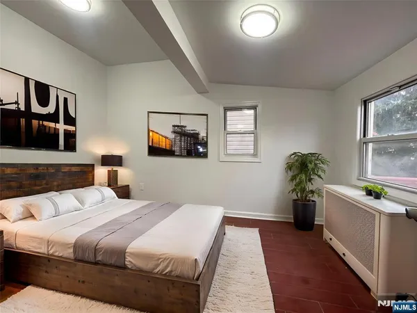 a bedroom with a large bed and a couch