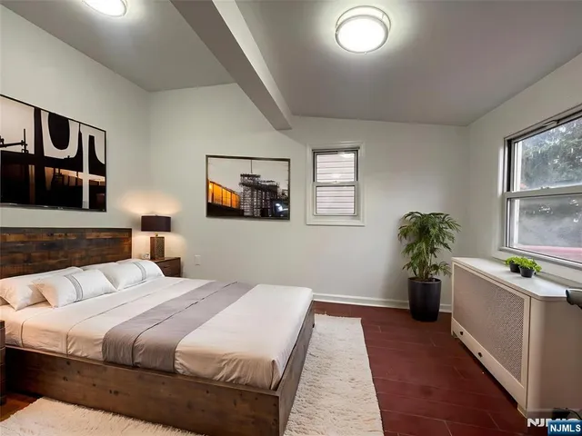 a bedroom with a large bed and a couch