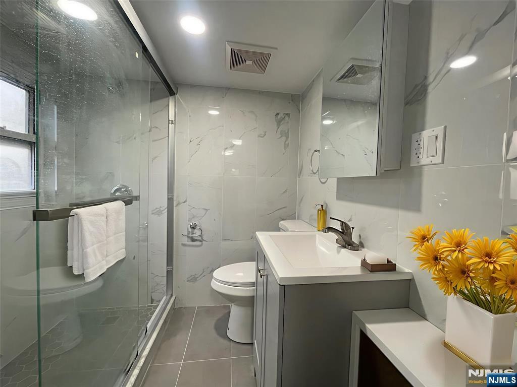 40 Searing Avenue, Unit 2 Harrison, NJ 07029 - Photo 4 of 11 a bathroom with a sink toilet and shower