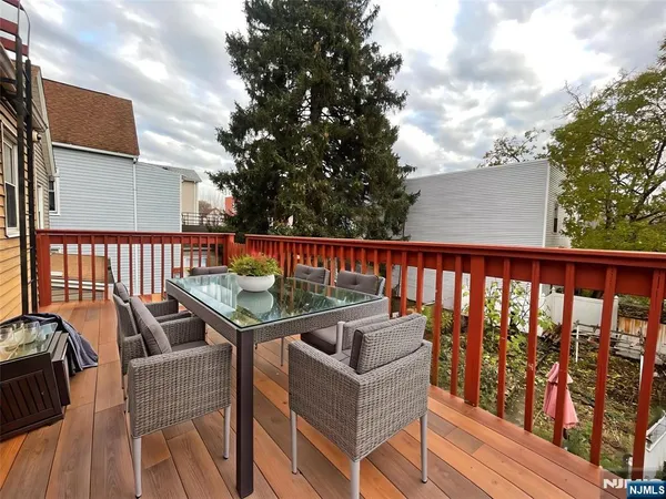 a balcony with furniture and wooden floor