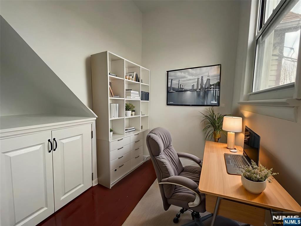 40 Searing Avenue, Unit 2 Harrison, NJ 07029 - Photo 7 of 11 a view of a workspace with furniture and a window