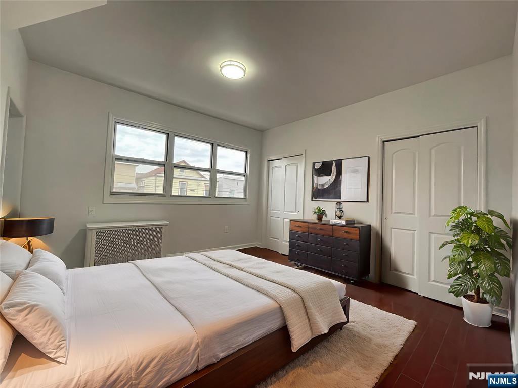 40 Searing Avenue, Unit 2 Harrison, NJ 07029 - Photo 8 of 10 a bedroom with a bed and a potted plant