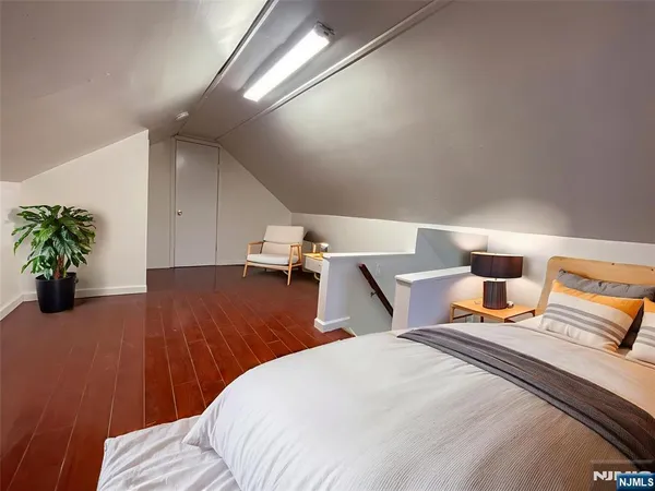 a bedroom with a bed and a potted plant