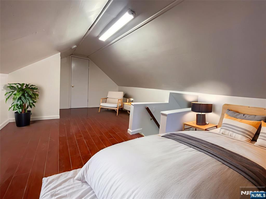 40 Searing Avenue, Unit 2 Harrison, NJ 07029 - Photo 9 of 10 a bedroom with a bed and a potted plant