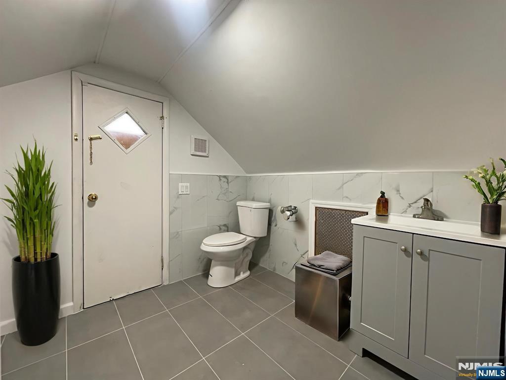 40 Searing Avenue, Unit 2 Harrison, NJ 07029 - Photo 10 of 11 a bathroom with a toilet sink and shower