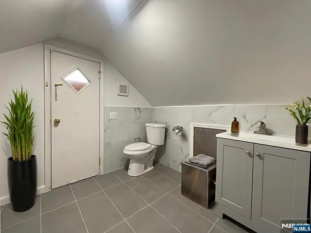 a bathroom with a toilet sink and shower