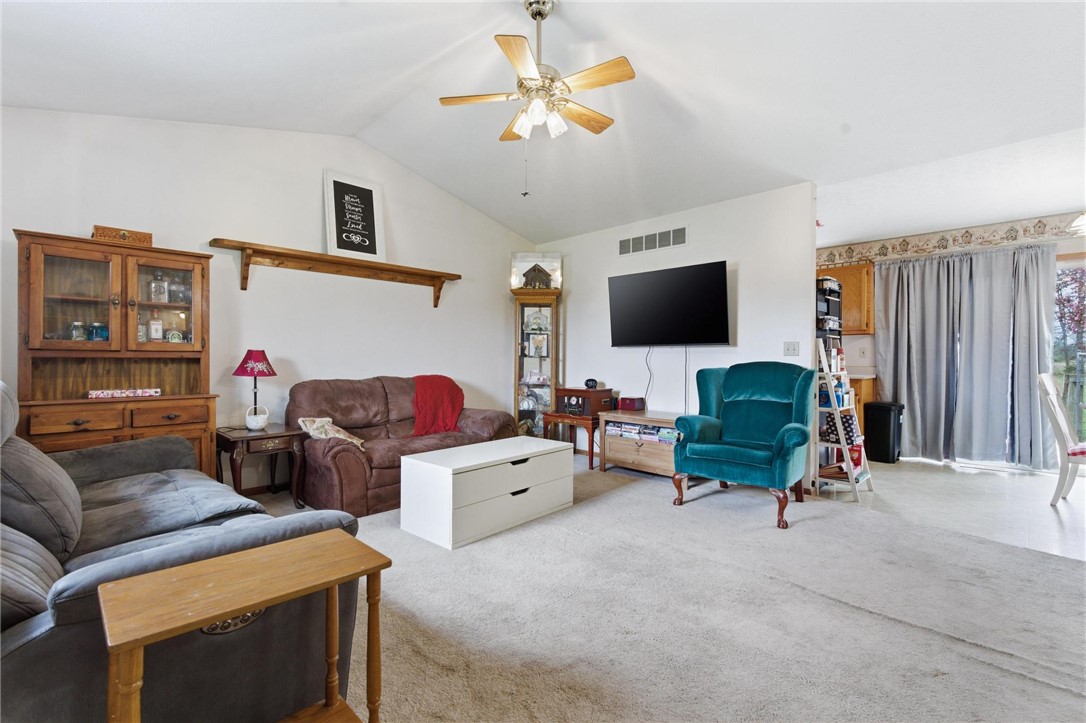 8747 Waynes Way Blanchester, OH 45107 - Photo 6 of 40 This inviting living space features high ceilings and soft carpeting, creating a comfortable atmosphere.