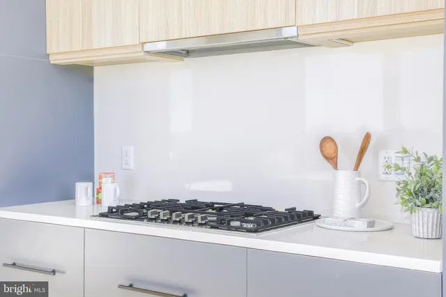 a kitchen with sink stove and cabinets