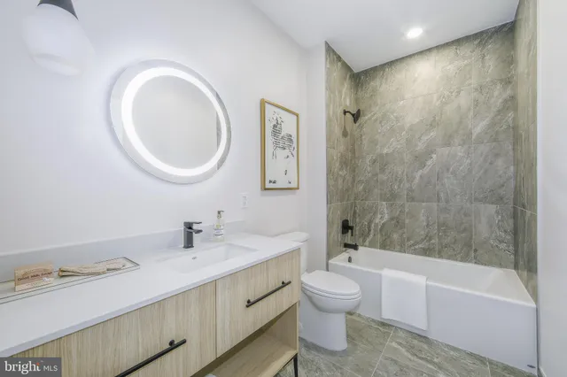 a living room with a bed and a large window