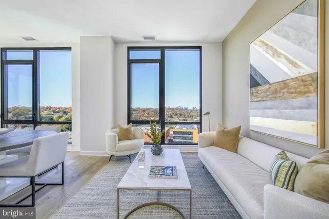 a living room with furniture and floor to ceiling window