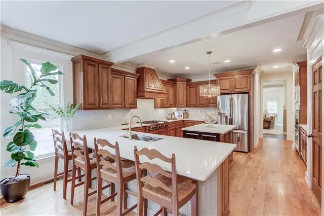 a living room with furniture a chandelier and a fireplace