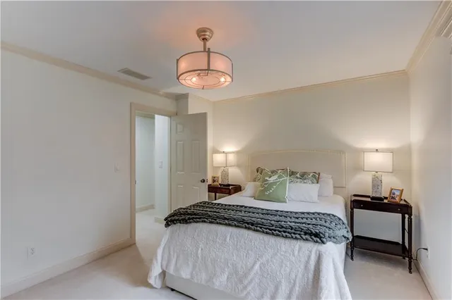 a bedroom with a bed and a large mirror