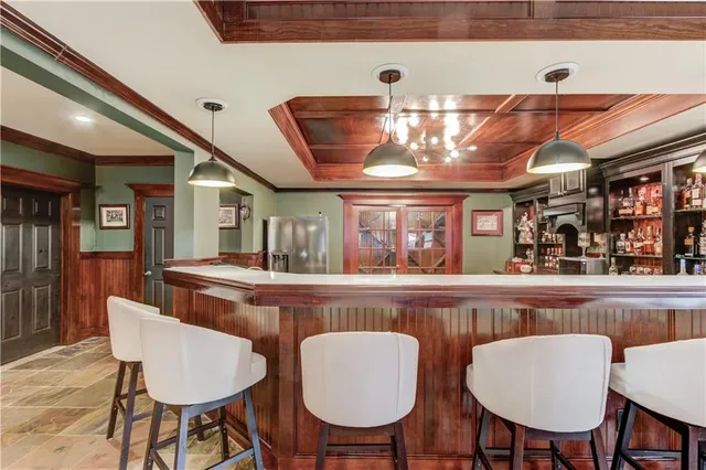 a living room with furniture and floor to ceiling windows