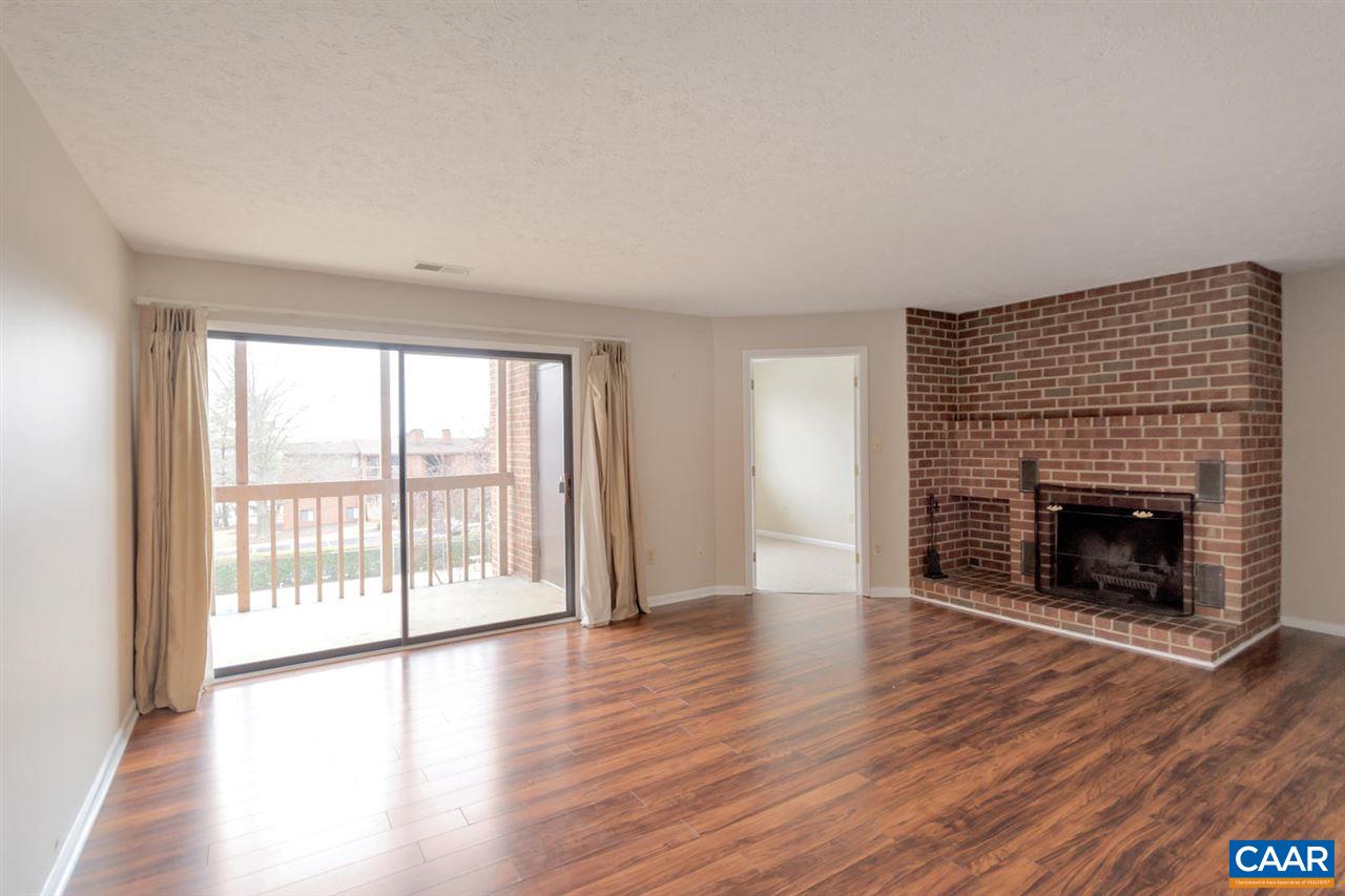 130 Turtle Creek Road, Unit 6 Charlottesville, VA 22901 - Photo 6 of 15 wooden floor fireplace and windows in an empty room