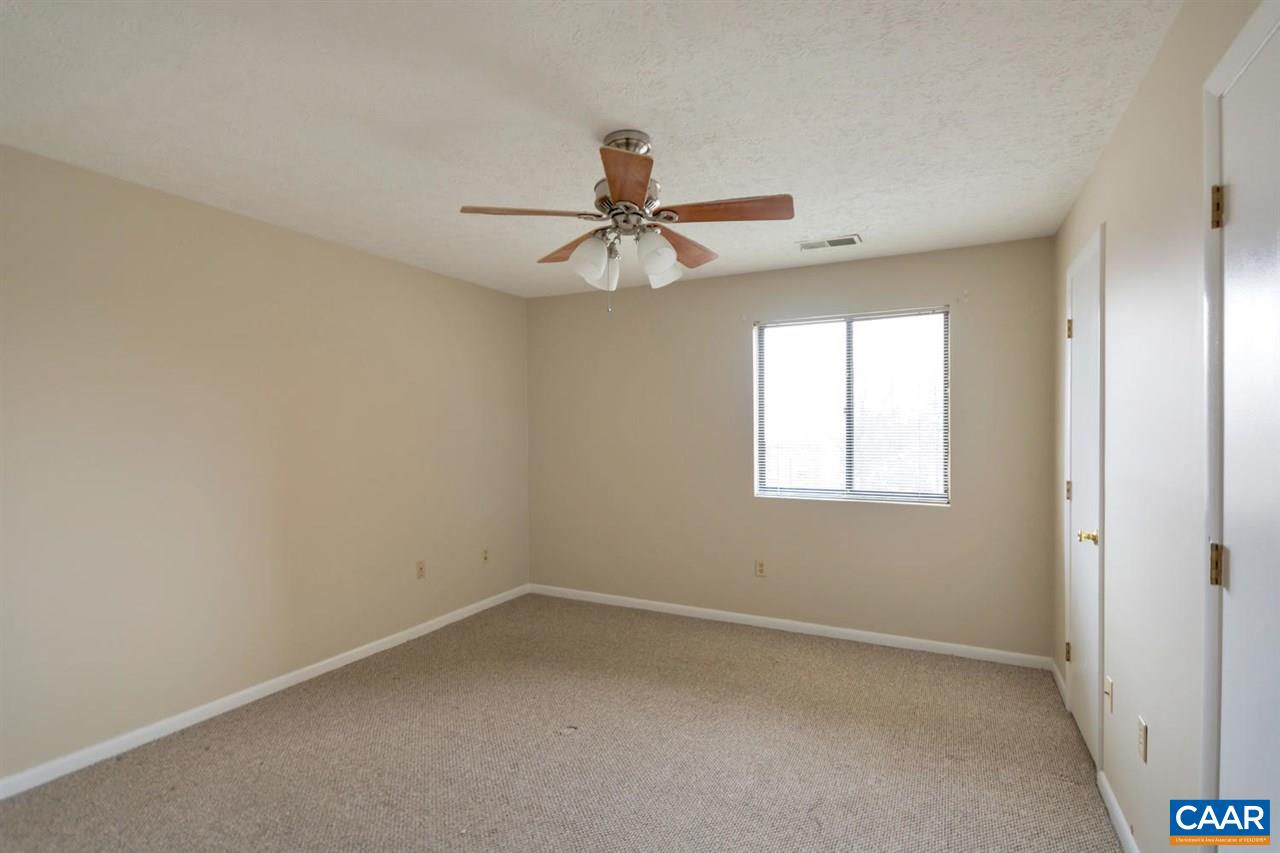 130 Turtle Creek Road, Unit 6 Charlottesville, VA 22901 - Photo 9 of 15 an empty room with a window and a fan