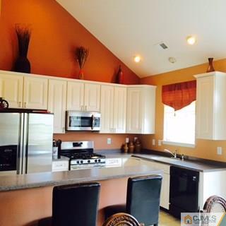 2 Pebble Creek Road Dayton, NJ 08810 - Photo 2 of 22 a kitchen with stainless steel appliances granite countertop a stove a sink a microwave a refrigerator and cabinets
