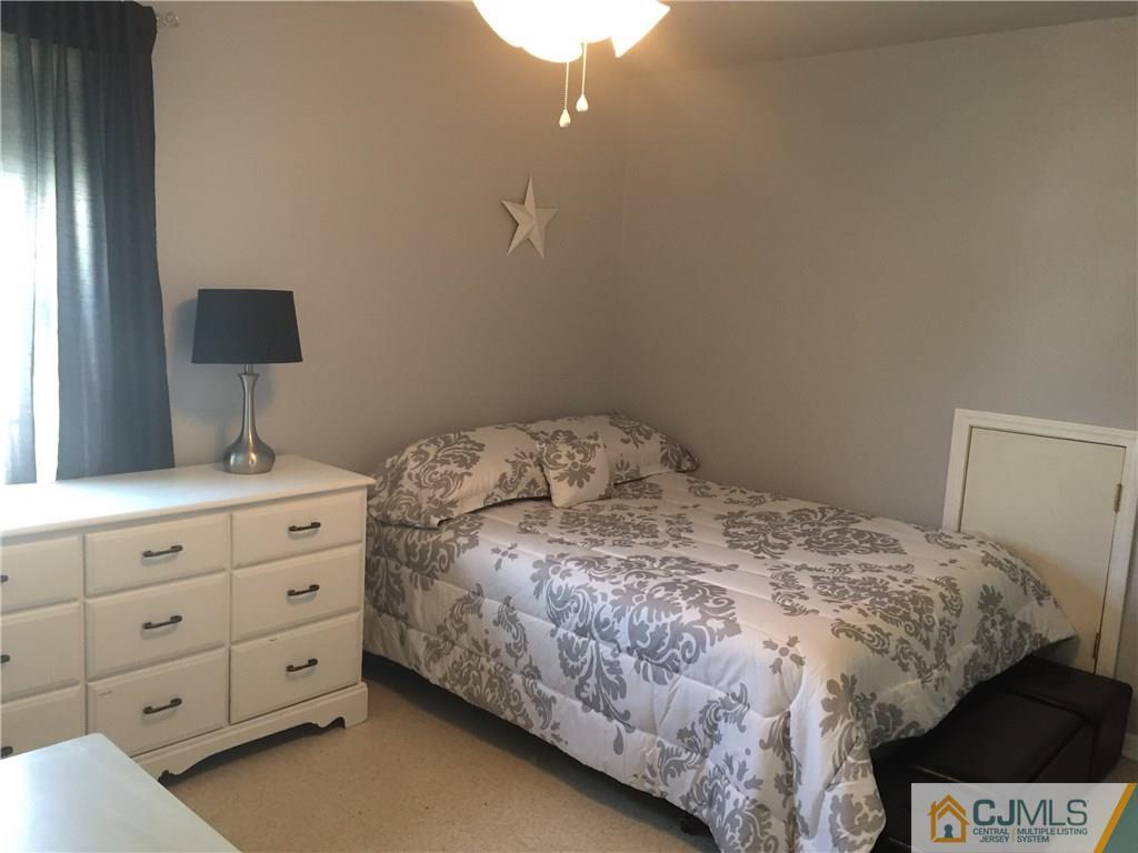 2 Pebble Creek Road Dayton, NJ 08810 - Photo 14 of 22 a bedroom with a bed and a lamp
