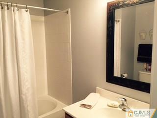 2 Pebble Creek Road Dayton, NJ 08810 - Photo 15 of 22 a bathroom with a sink and a mirror