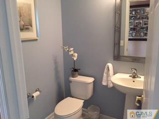 2 Pebble Creek Road Dayton, NJ 08810 - Photo 17 of 22 a bathroom with a toilet a sink and mirror