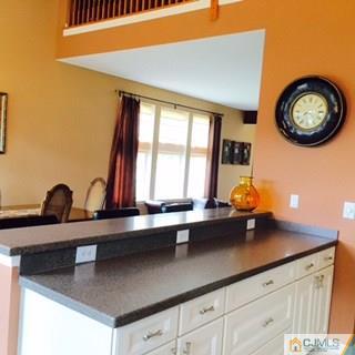 2 Pebble Creek Road Dayton, NJ 08810 - Photo 3 of 22 a view of a sink a mirror and a clock on the wall