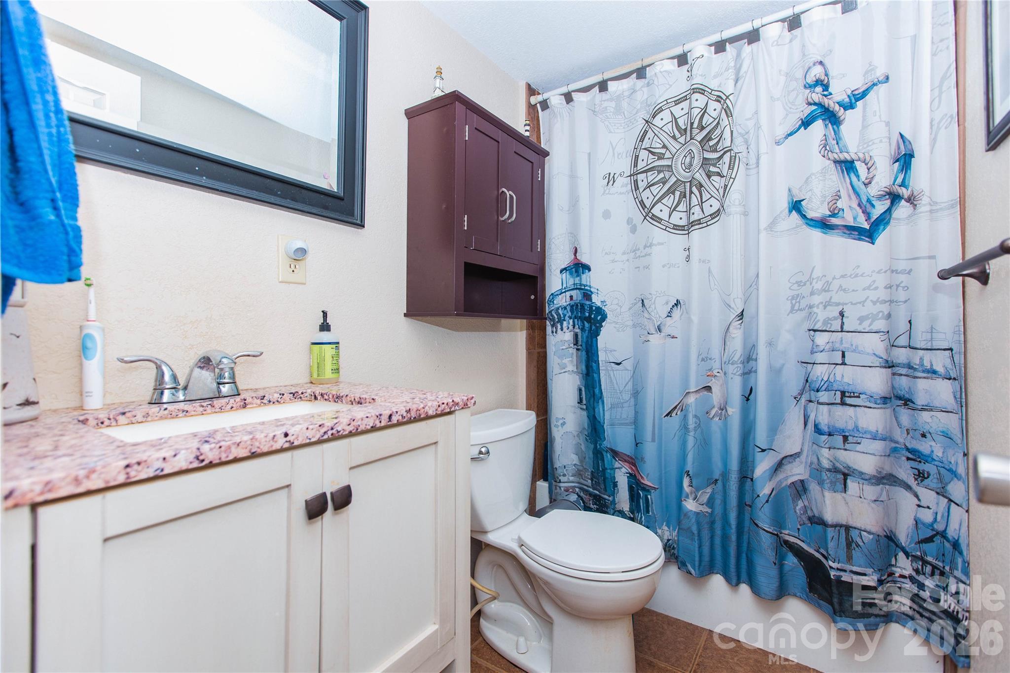 839 Hidden View Loop Marion, NC 28752 - Photo 11 of 32 a bathroom with a granite countertop toilet sink and mirror