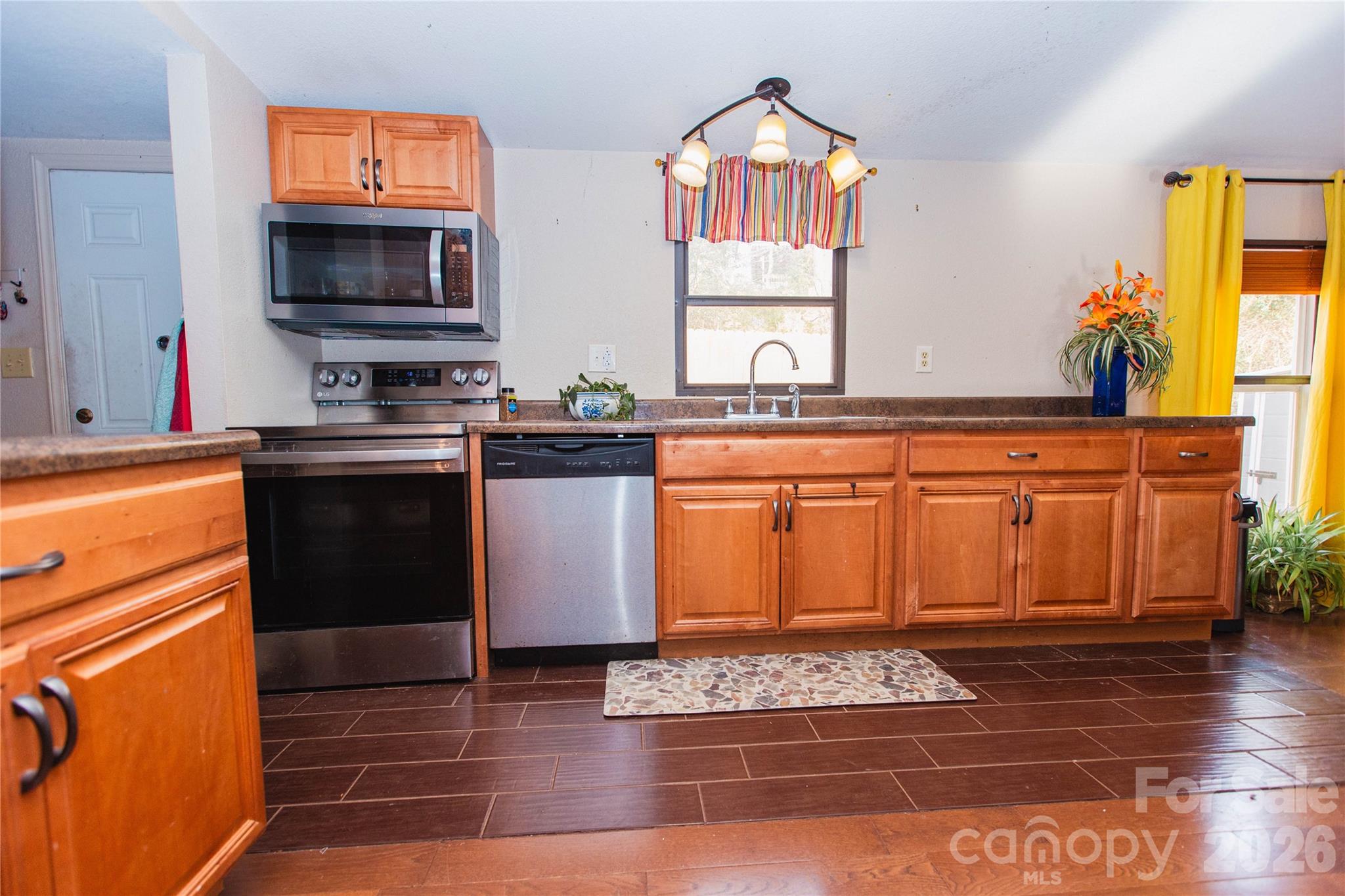 839 Hidden View Loop Marion, NC 28752 - Photo 23 of 32 a kitchen with stainless steel appliances granite countertop a stove a sink and a microwave