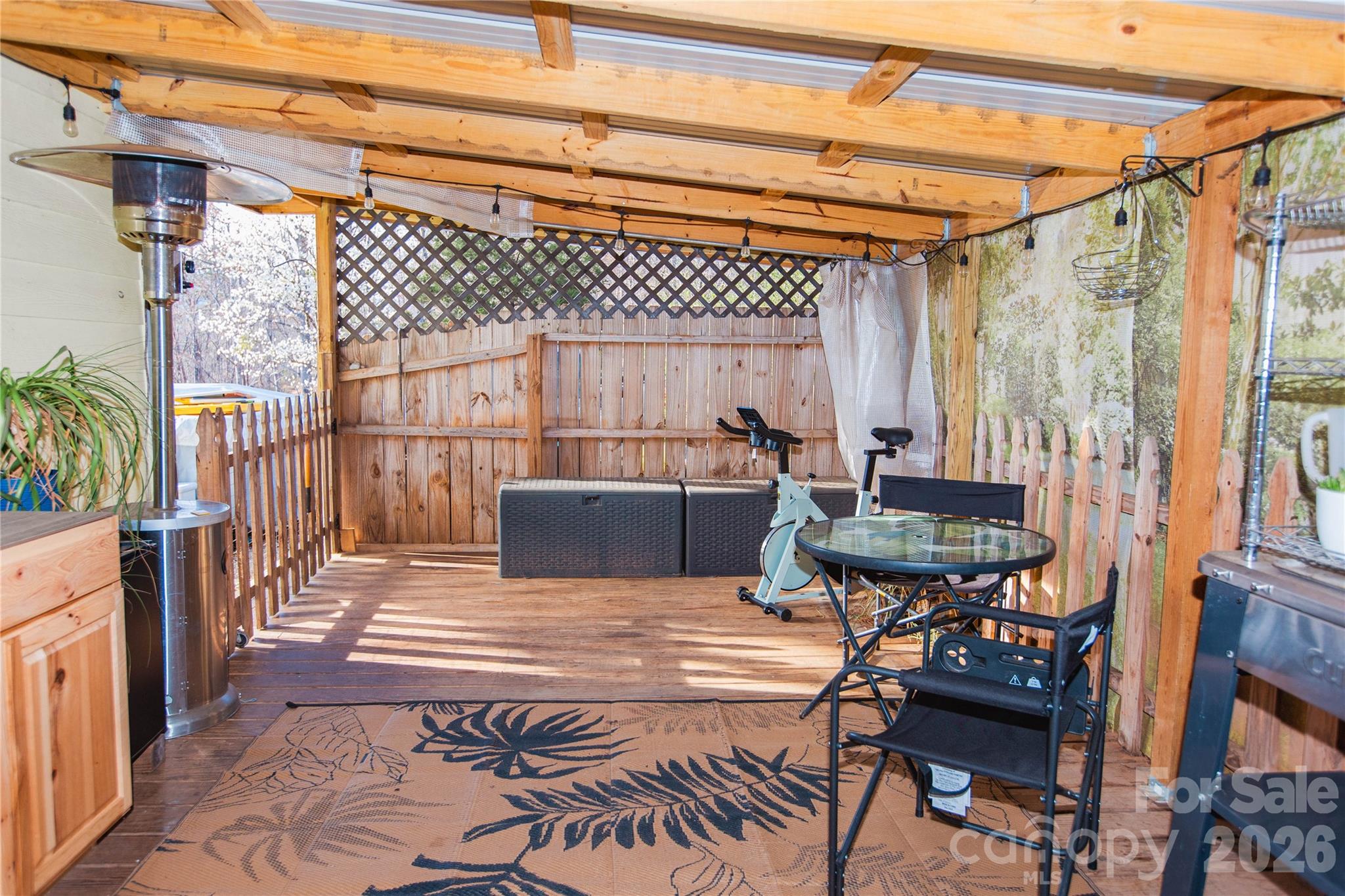 839 Hidden View Loop Marion, NC 28752 - Photo 29 of 32 a view of a patio with table and chairs with wooden floor and fence