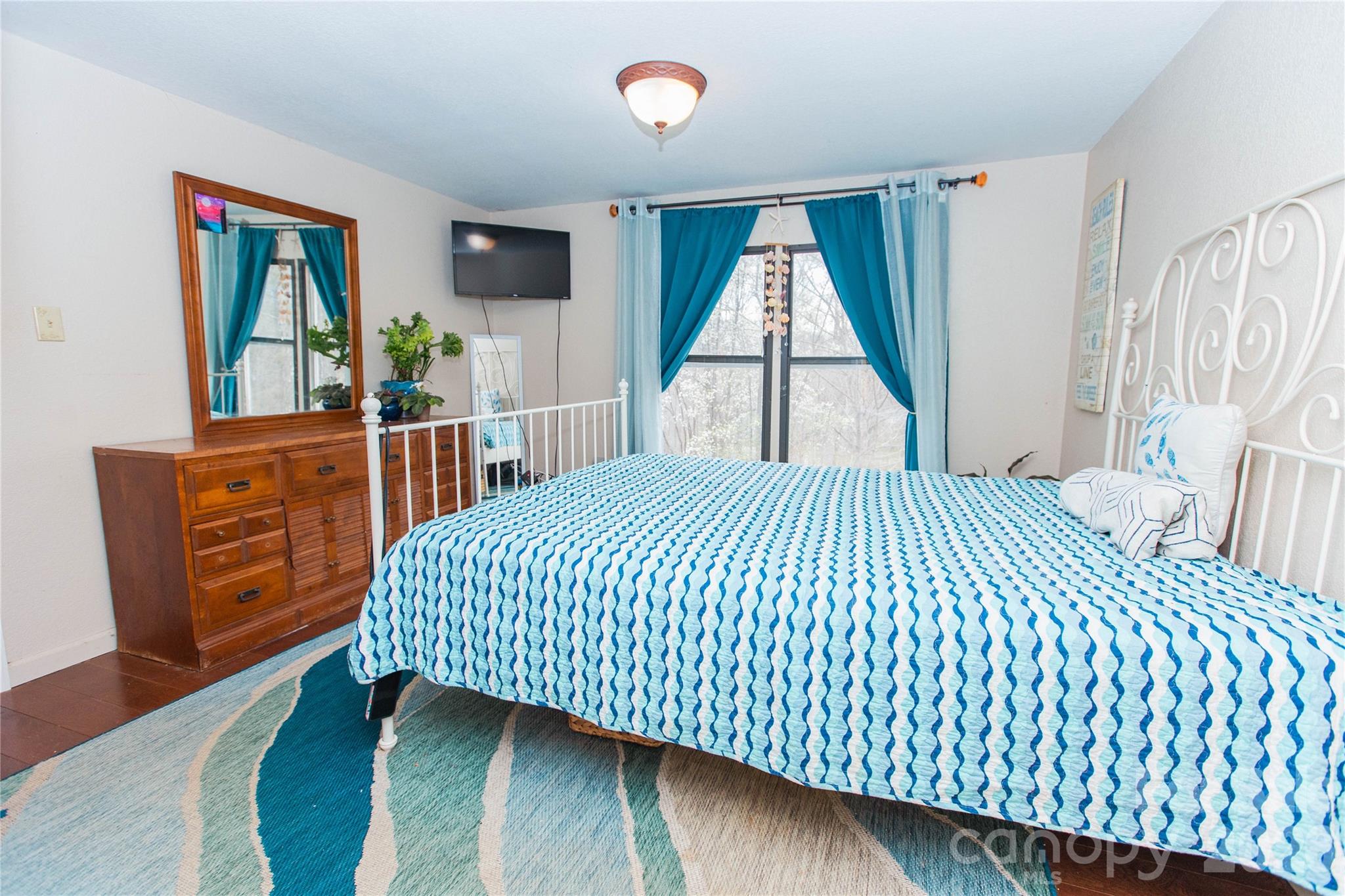 839 Hidden View Loop Marion, NC 28752 - Photo 7 of 32 a bedroom with a bed and a dresser next to a window