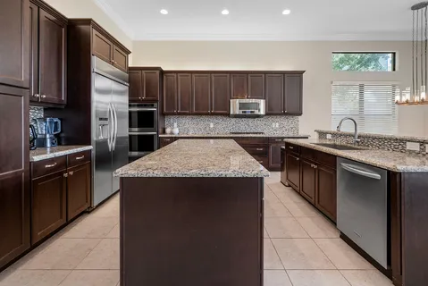 a living room with furniture a fireplace and kitchen view