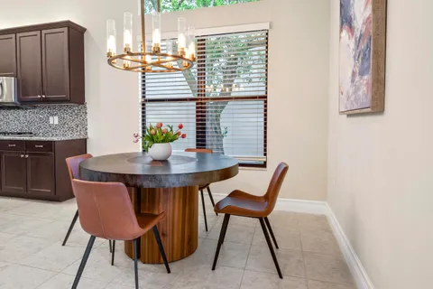 a living room with furniture fireplace and a large window