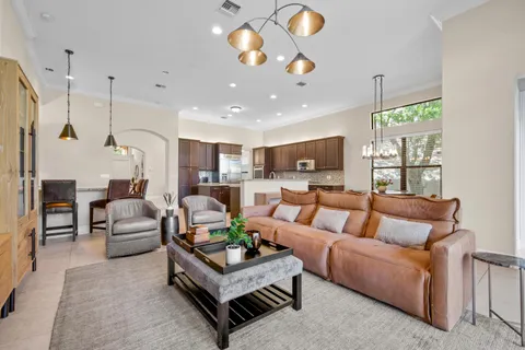 a kitchen with a dining table cabinets and stainless steel appliances