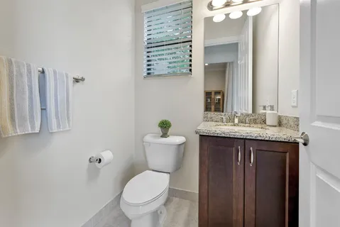 a bedroom with a bed lamps and window