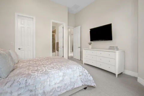 a bathroom with a granite countertop sink a toilet and a mirror